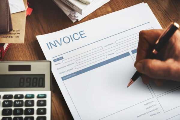a pad with written invoice in upper with white pages