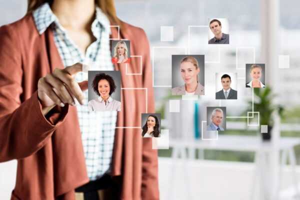A girl hand with digital screen with many persons trying to touch someone